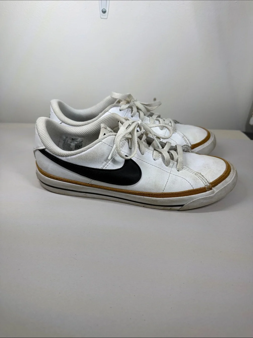 Nike White Low-Top Sneakers with Black Swoosh and Brown Trim